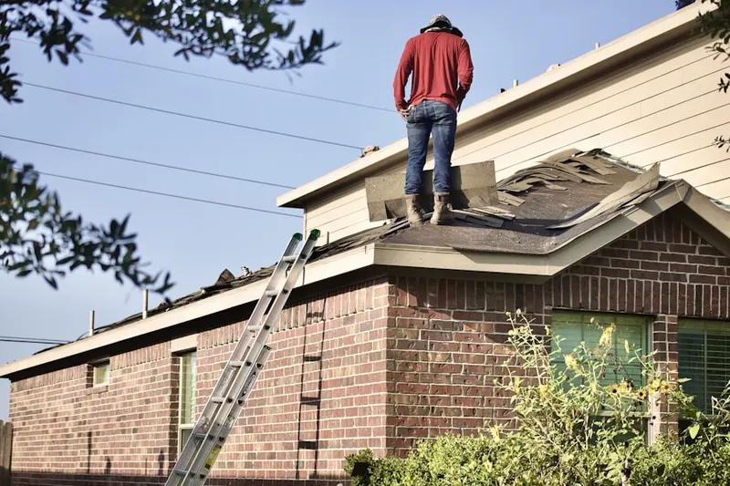 Professional roofer working on a residential roof in Pennellville
